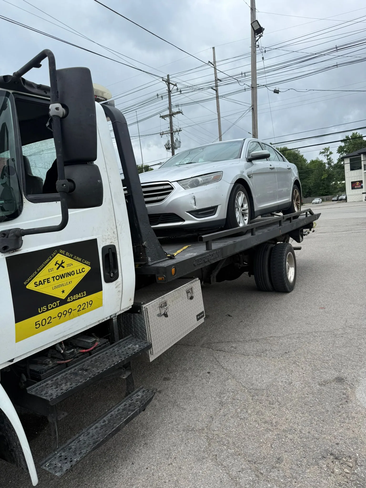 Sedan towing on flatbed in Louisville